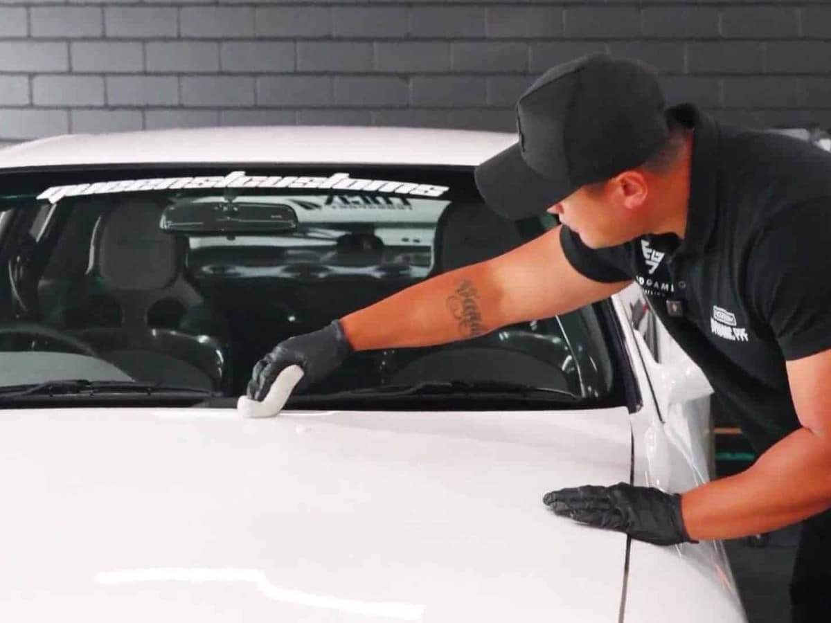 End Game Detailing technician applying Feynlab ceramic coating to a white Nissan R32 GT-R bonnet