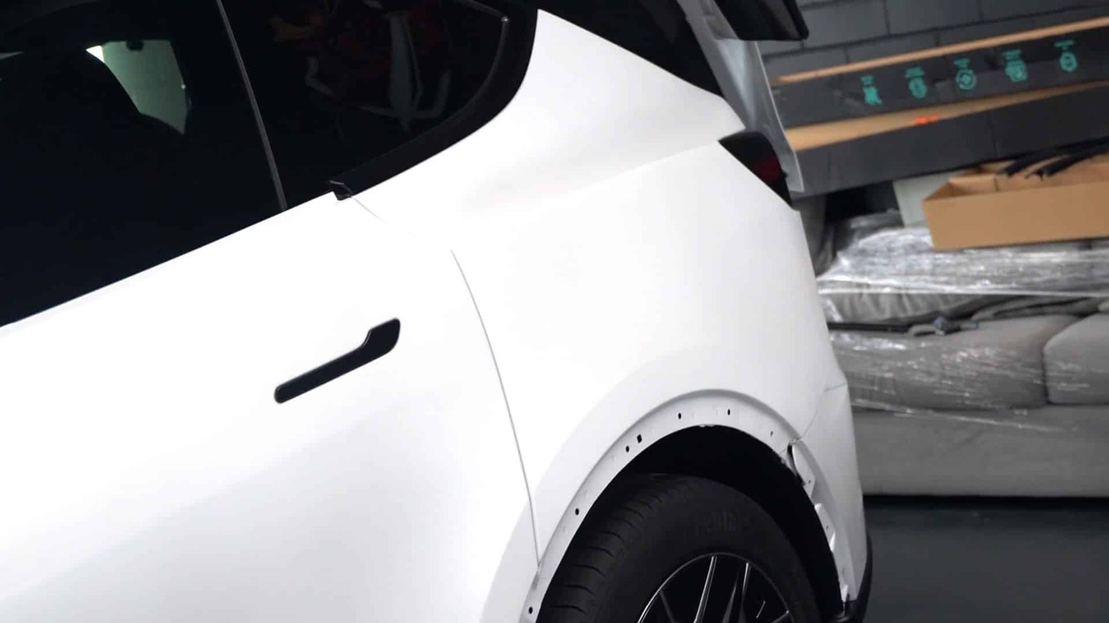 White Tesla rear door and quarter panel protected with paint protection film at End Game Detailing